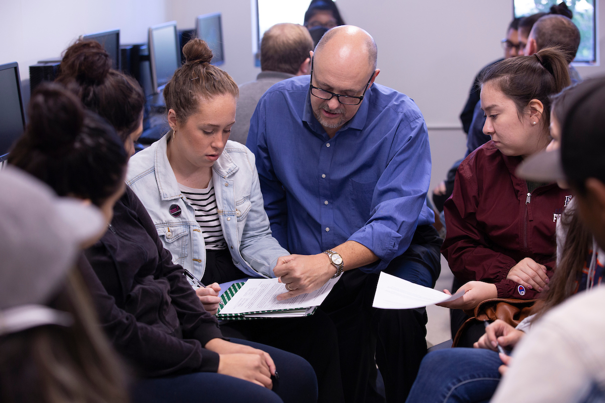 professor working with student in class