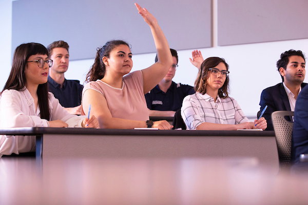 student raising her hand in class