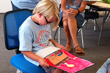 Kid reading to a group