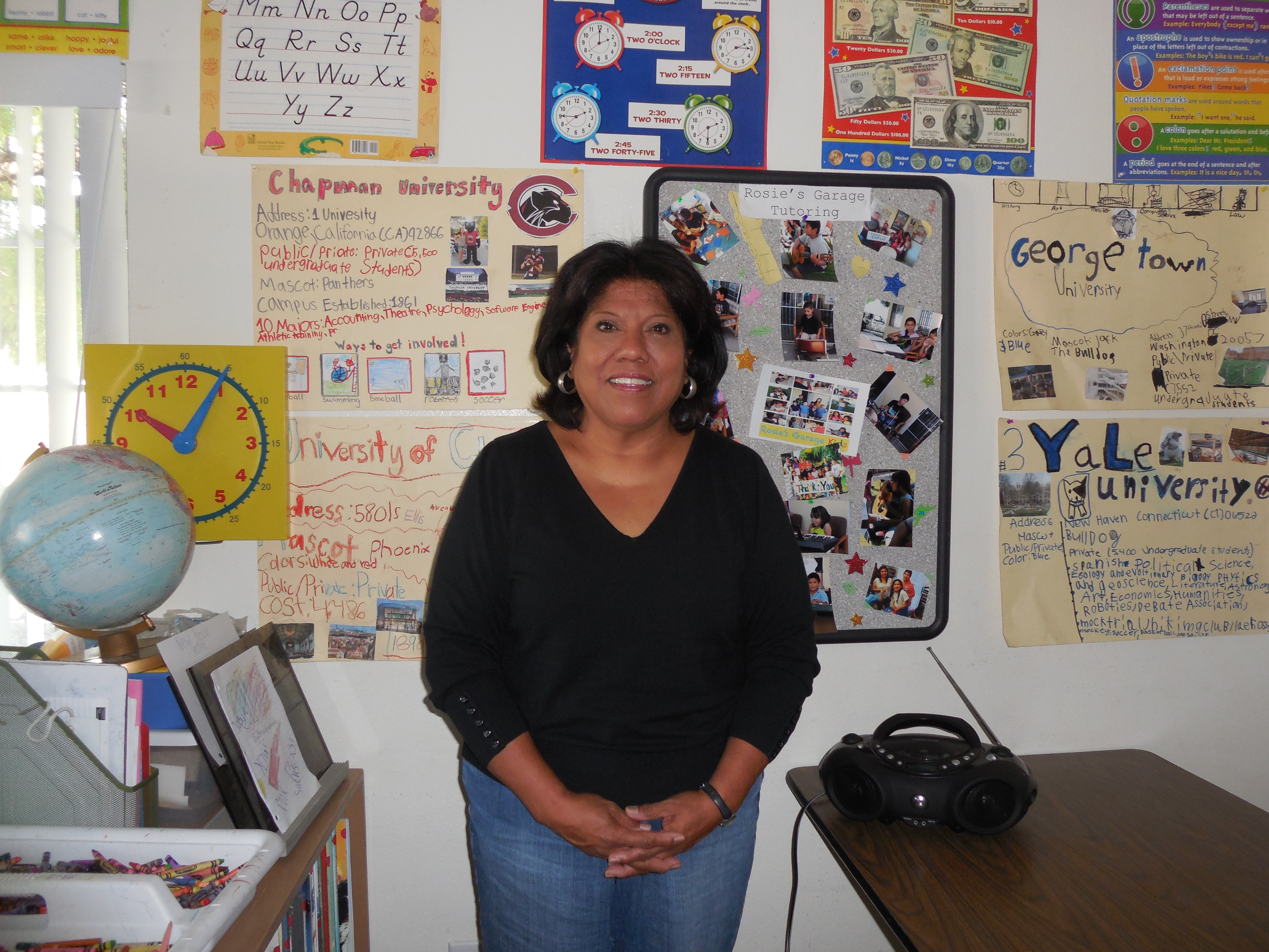 Rose Espinoza stands in front of a classroom background